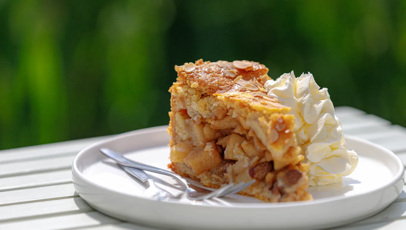 Selective focus of a piece of apple pie on white plate served with whipping cream on the side, Homemade apple pie on wooden table with blurred green garden background.
1787711810
Typically Dutch foods
