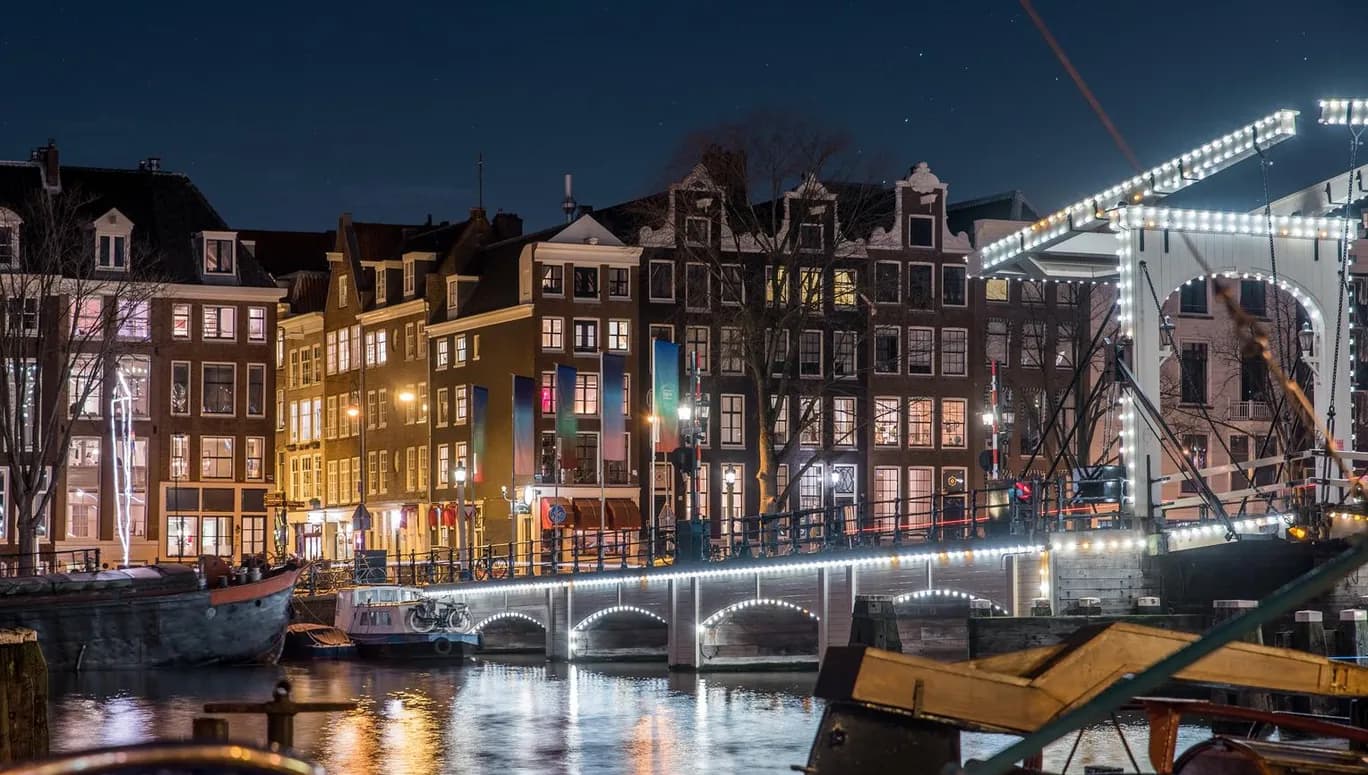Scenic view of Amsterdam city and the river Amstel bridge at night (it's the Magere brug)