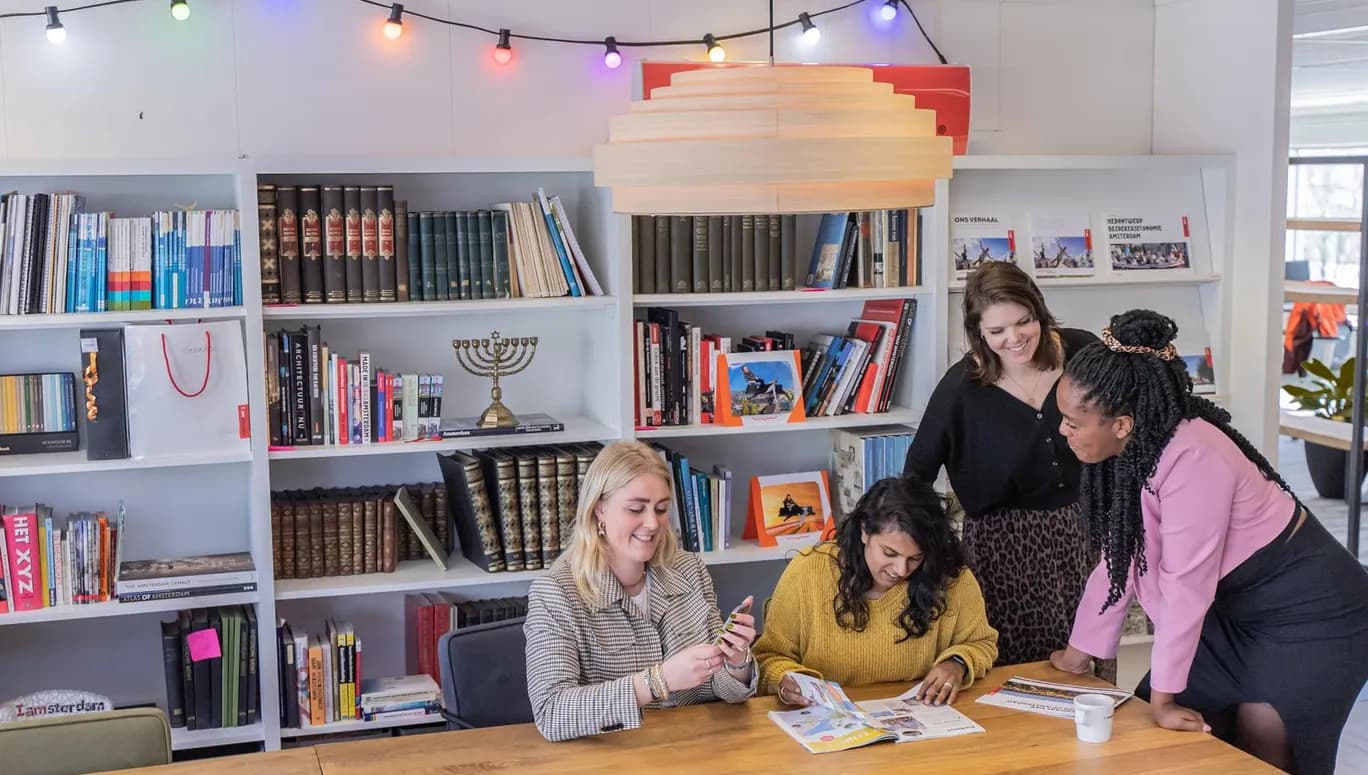 Colleagues working and  reading in the meeting room