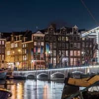 Scenic view of Amsterdam city and the river Amstel bridge at night (it's the Magere brug)