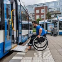 A person in a wheelchair taking the tram.