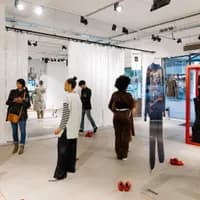 People looking at clothes at the  new normal gallery