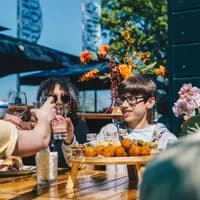 People making a toast with borrelplank and bitterballen at Theehuis Cruquius.