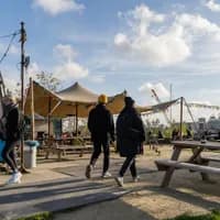 A couple is walking onto the terrace of café-restaurant and cultural hotspot Noorderlicht at NDSM.