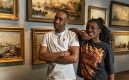 A couple visits Het Scheepvaartmuseum.