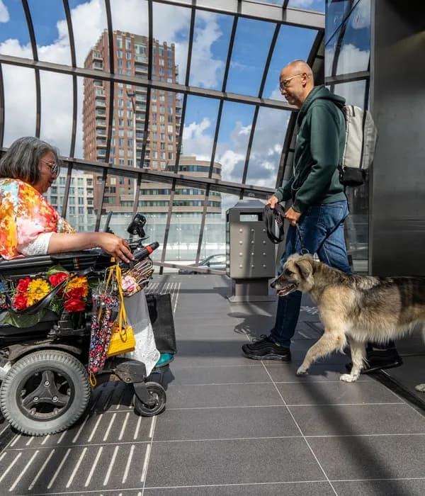 A person in an electric wheelchair on the metro platform waiting before entering the elevator in Noord.