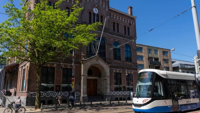 A tram passing music venue Paradiso at Weteringschans near Leidseplein.