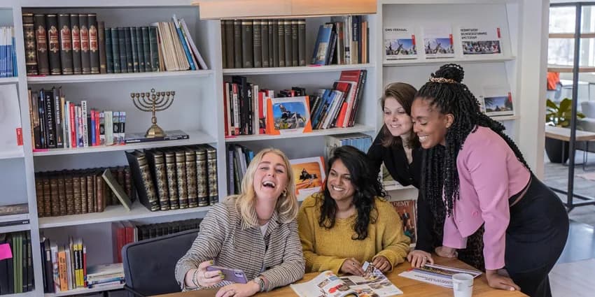 Colleagues working and  reading in the meeting room