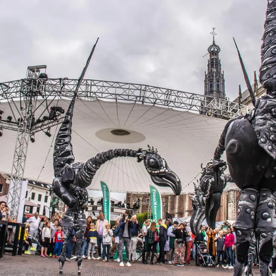 Grote Markt, Haarlem, Haarlem Culinair. Performers and art installations with visitors enjoying food at drinks at Haarlem Culinair food festival at the Grote Markt