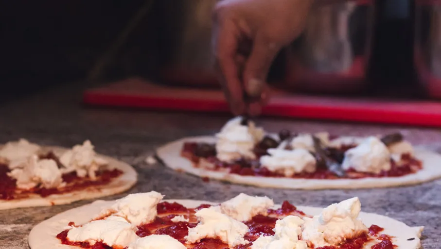 Pizza preparation at La Perla