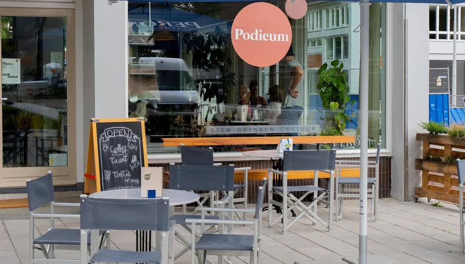 Neighborhood café, Podiuem exterior with open sign outside and terrace.