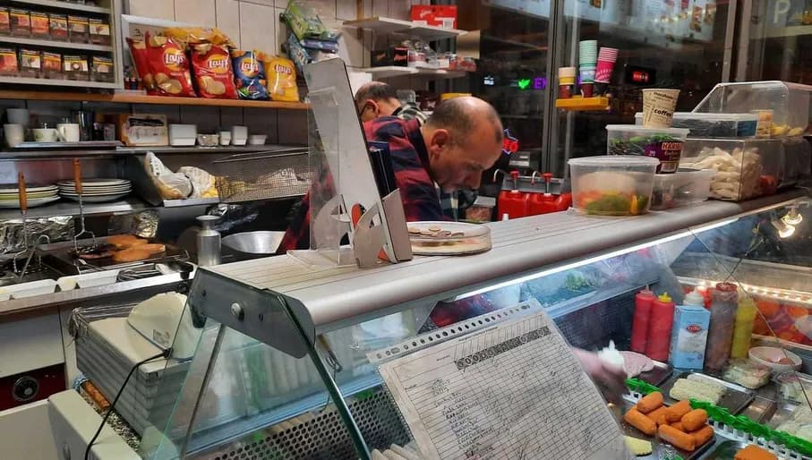 Attentive chef choosing from display of delicious products at Snack Bar De Dijk romantic restaurant