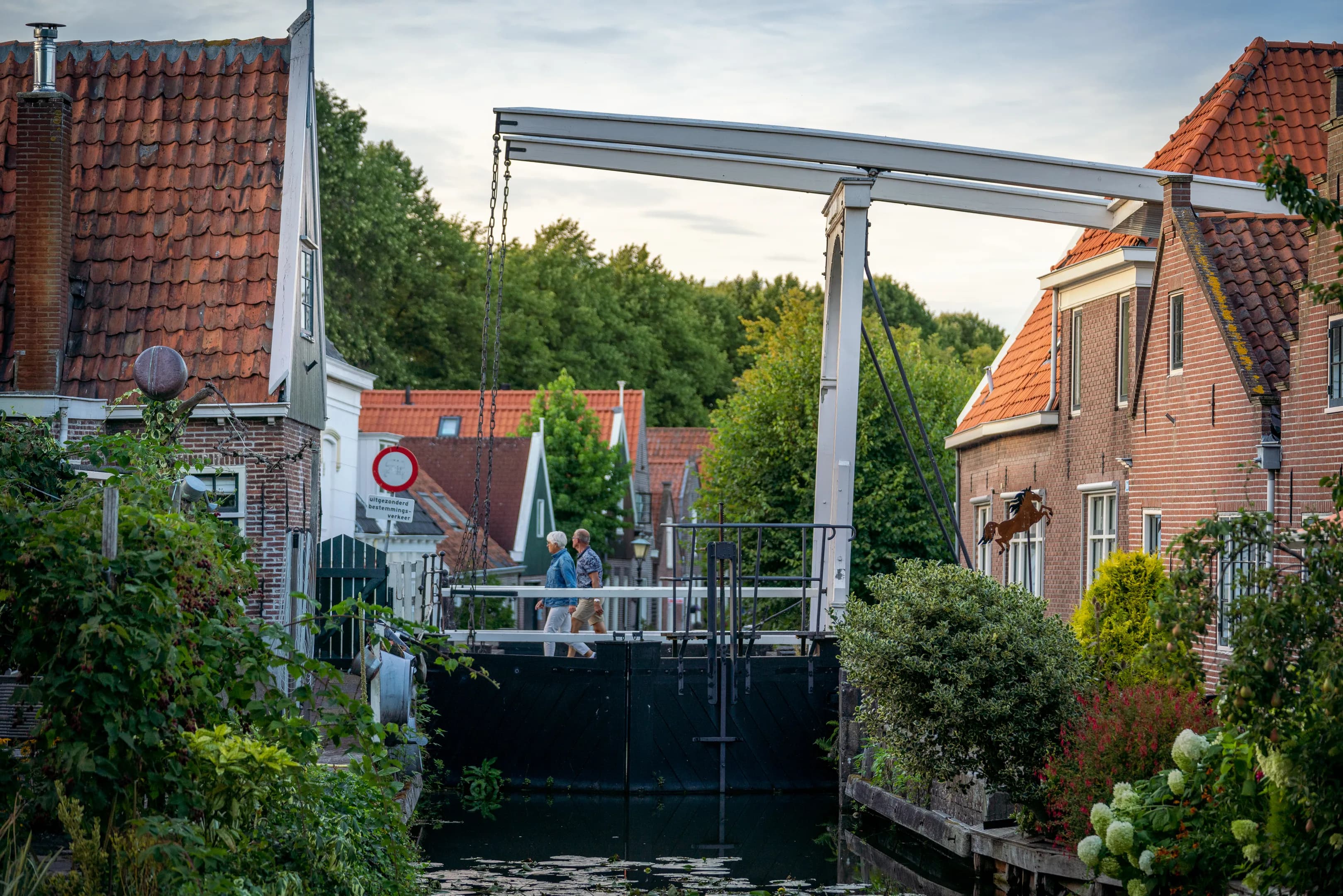 People walking over a bridge in Edam.