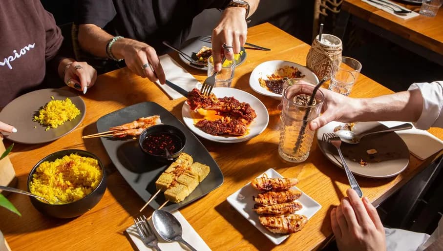 AMOI Asian restaurant, group eating food, rice and dumplings