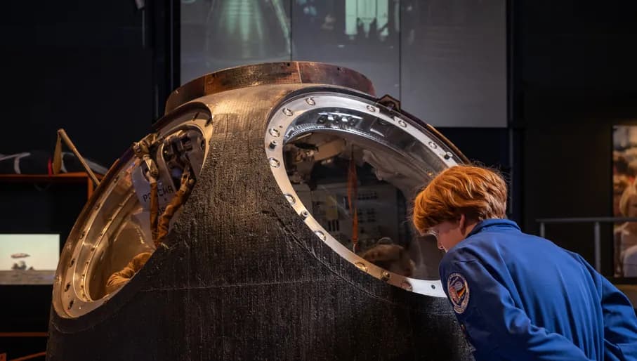 boy looking at astronaut exposition
