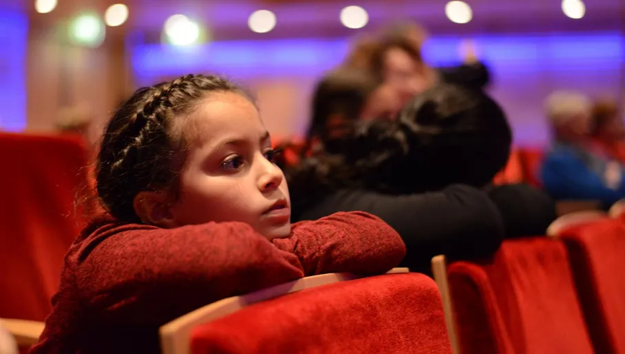 Child listening to music at Muziekgebouw aan 't IJ Youth Concert children's performance